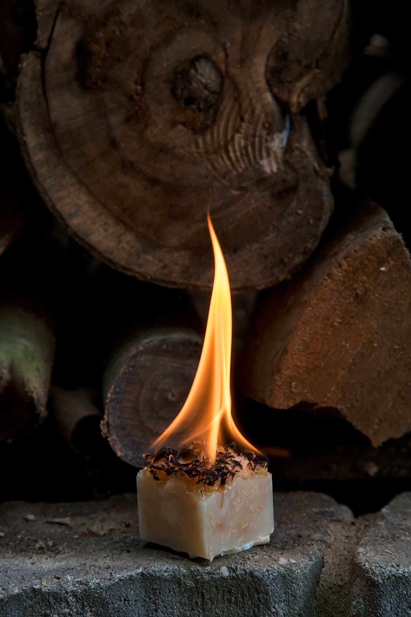 Single Burning Fire Starter in Front of Firewood. Guaranteed to burn for 20 minutes