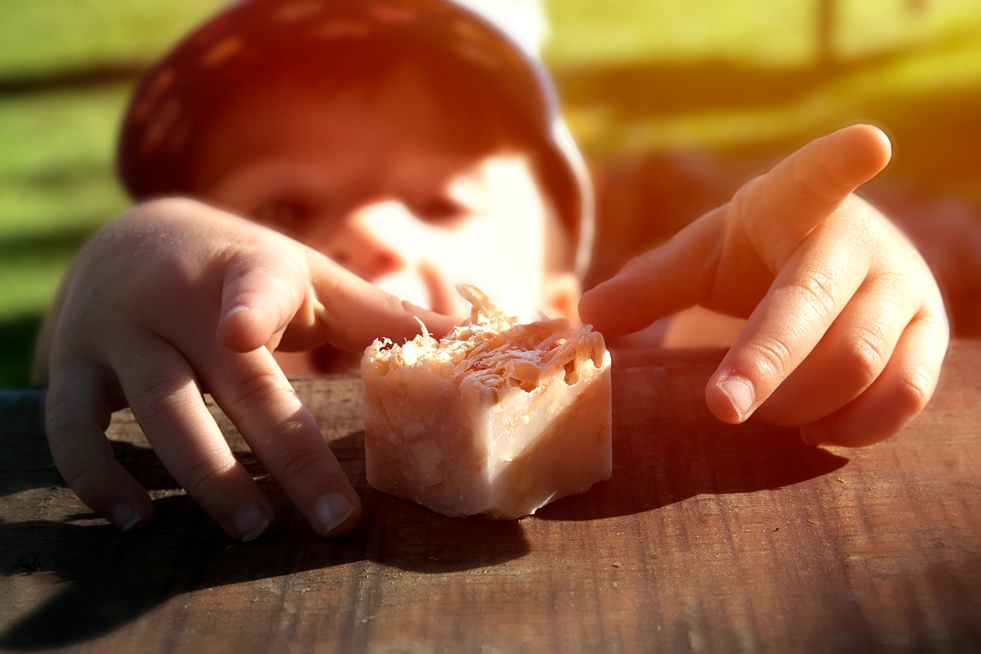 Child reaching for single 100% organic fire starter on table